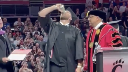 Travis Kelce chugs a beer at graduation ceremony